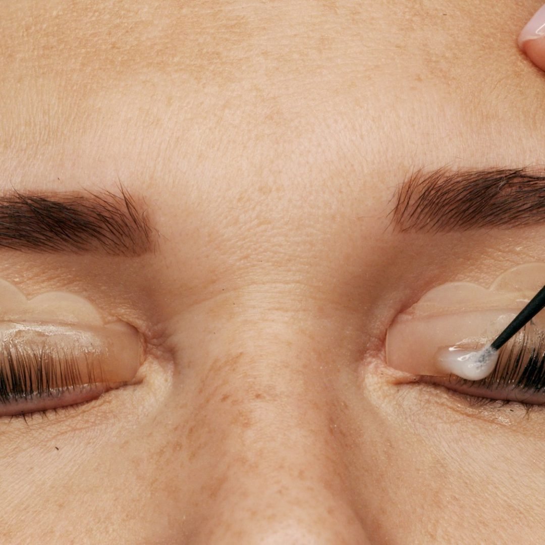 Woman on modern eyelash lamination procedure in a professional beauty salon.